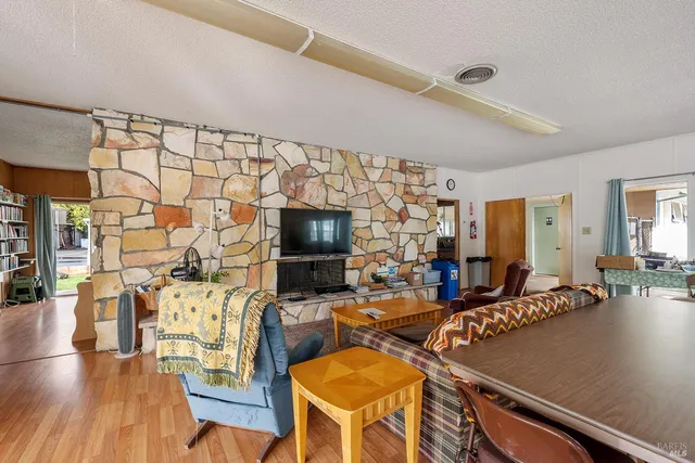 a living room with lots of furniture and view of kitchen