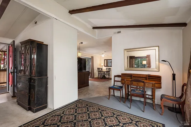 a dining room with furniture and a window