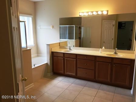 1816 Cross Pointe Way St. Augustine, FL 32092 - Photo 12 of 19 a spacious bathroom with a mirror sink and shower
