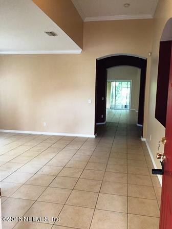 1816 Cross Pointe Way St. Augustine, FL 32092 - Photo 2 of 19 a view of a hallway to a livingroom with furniture