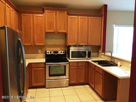 1816 Cross Pointe Way St. Augustine, FL 32092 - Photo 7 of 19 a kitchen with a sink stove and refrigerator