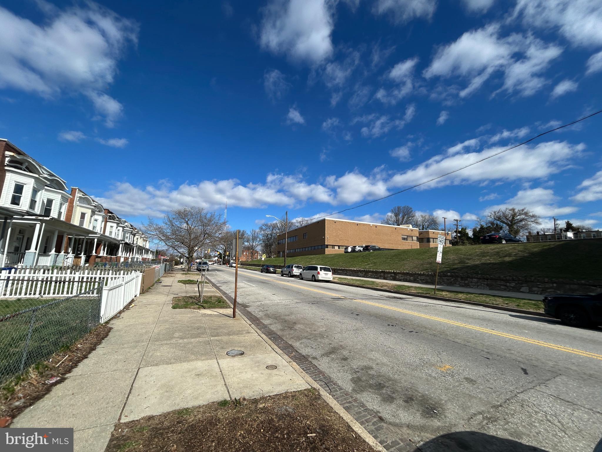 3912 Reisterstown Road Baltimore, MD 21215 - Photo 3 of 13 a view of city street with a yard