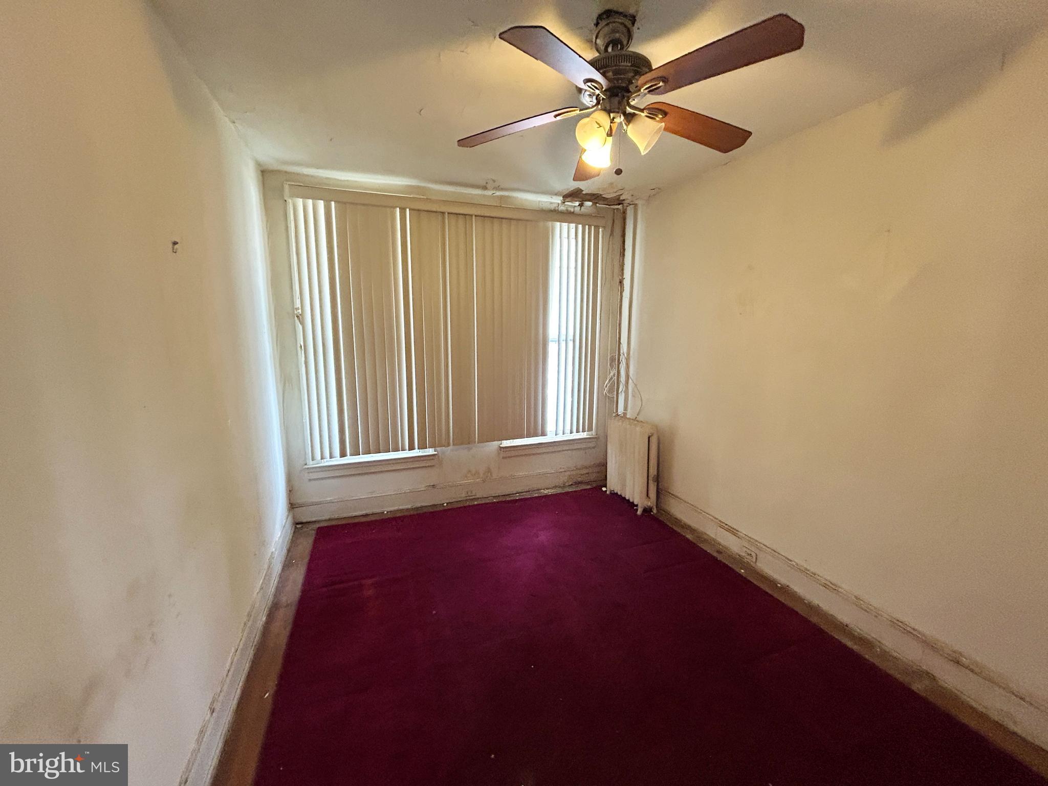 3912 Reisterstown Road Baltimore, MD 21215 - Photo 6 of 13 an empty room with windows and fan