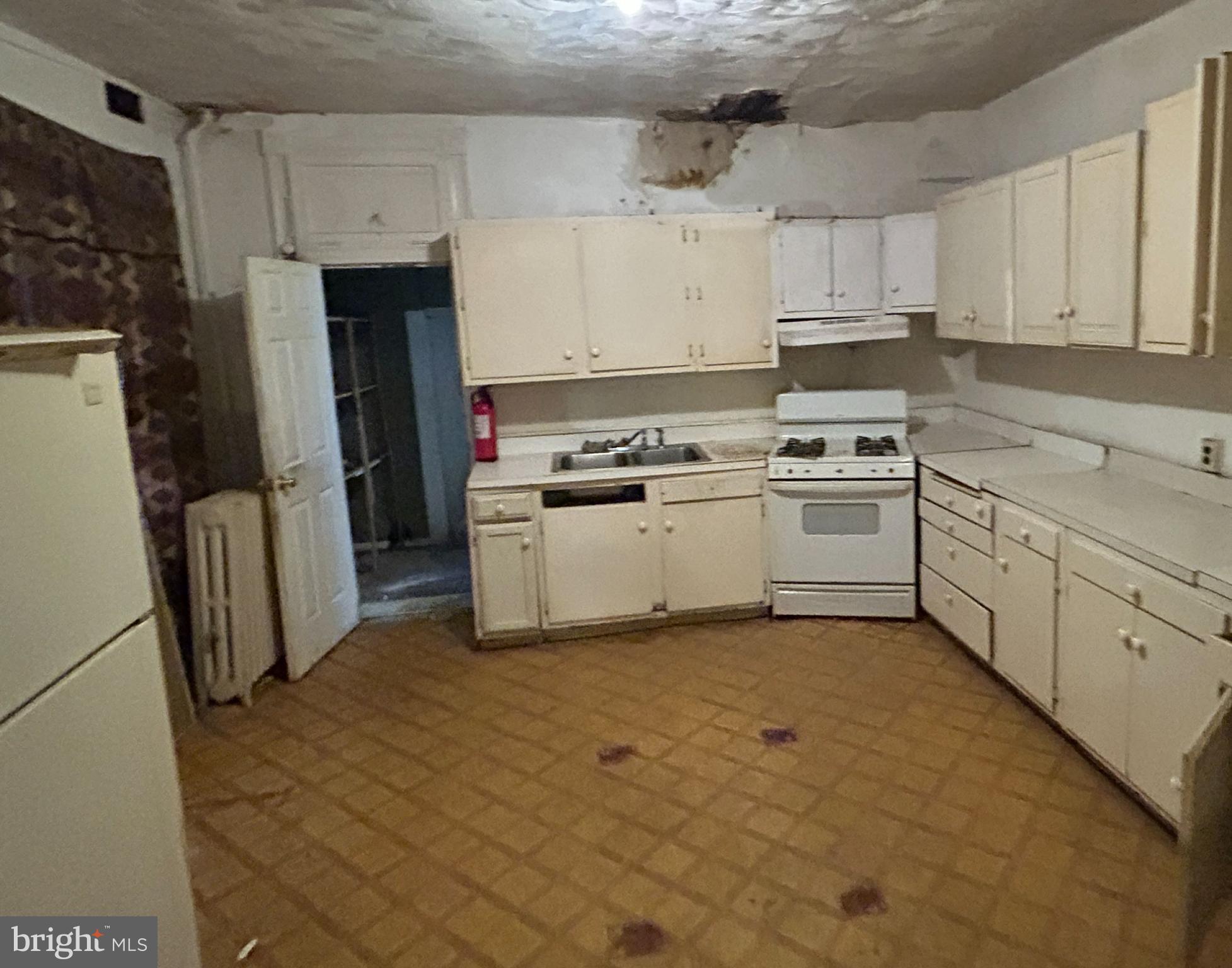 3912 Reisterstown Road Baltimore, MD 21215 - Photo 8 of 13 a kitchen with stainless steel appliances granite countertop a stove a sink and a refrigerator