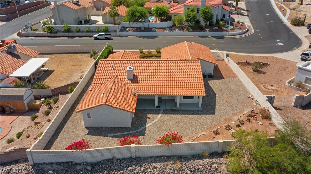 2055 Cholla Way Laughlin, NV 89029 - Photo 83 of 87 An aerial perspective reveals a private desert oasis with durable tile roofing and walled boundaries.