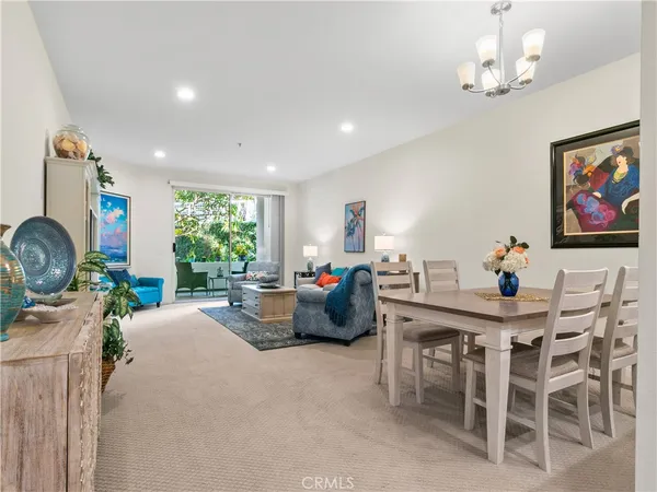 a living room with furniture a window and a chandelier