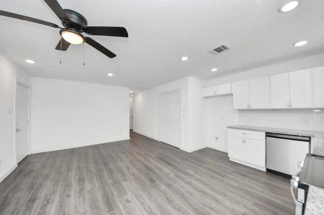 a kitchen with stainless steel appliances granite countertop a sink and stove top oven