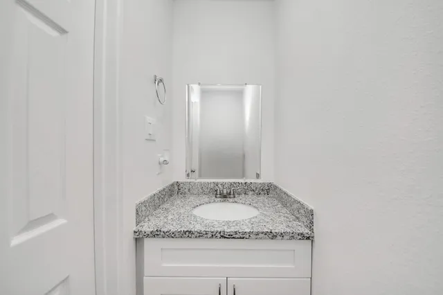 a view of a kitchen with wooden floor and electronic appliances