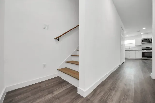 a view of a room with wooden floor and a window