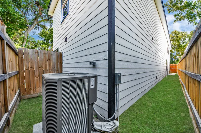 an aerial view of a house with a yard and large trees