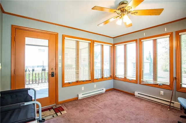 a living room with furniture and floor to ceiling windows
