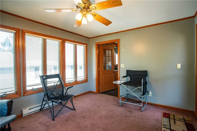 a living room with hardwood floor and ceiling fan