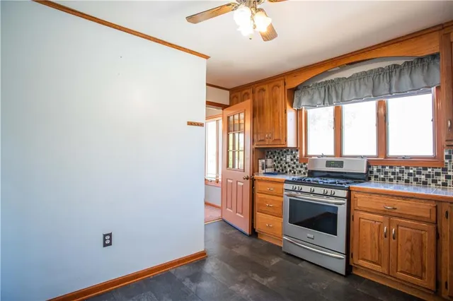 a kitchen with a stove and a wooden floor
