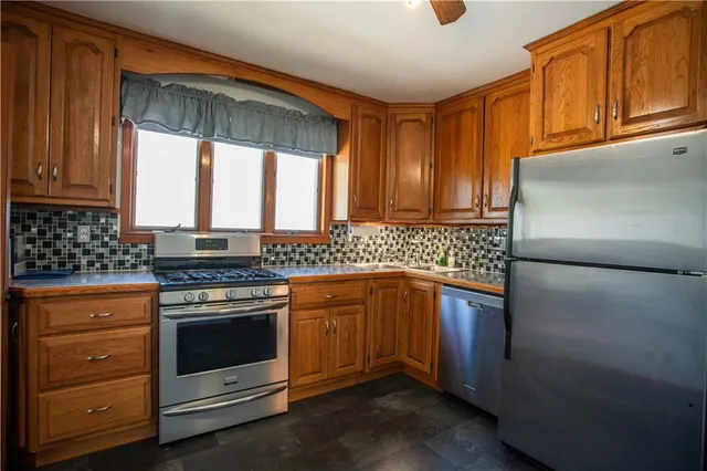 a kitchen with granite countertop cabinets stainless steel appliances and a sink