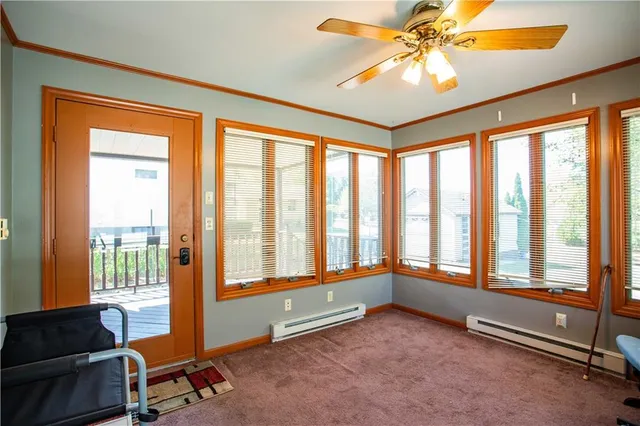 a living room with furniture and a floor to ceiling window