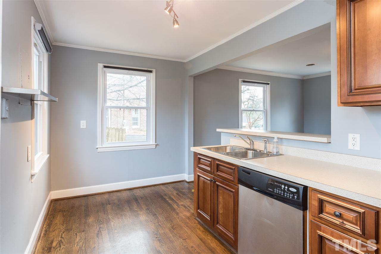 631 Brighton Road Raleigh, NC 27610 - Photo 12 of 25 a kitchen with stainless steel appliances granite countertop a sink and wooden floor
