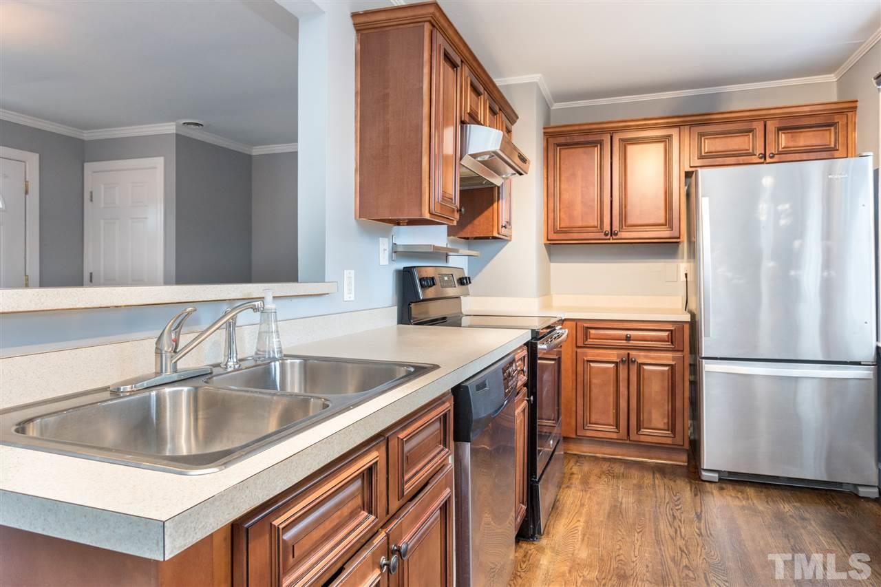 631 Brighton Road Raleigh, NC 27610 - Photo 13 of 25 a kitchen with stainless steel appliances granite countertop a sink a stove and a refrigerator