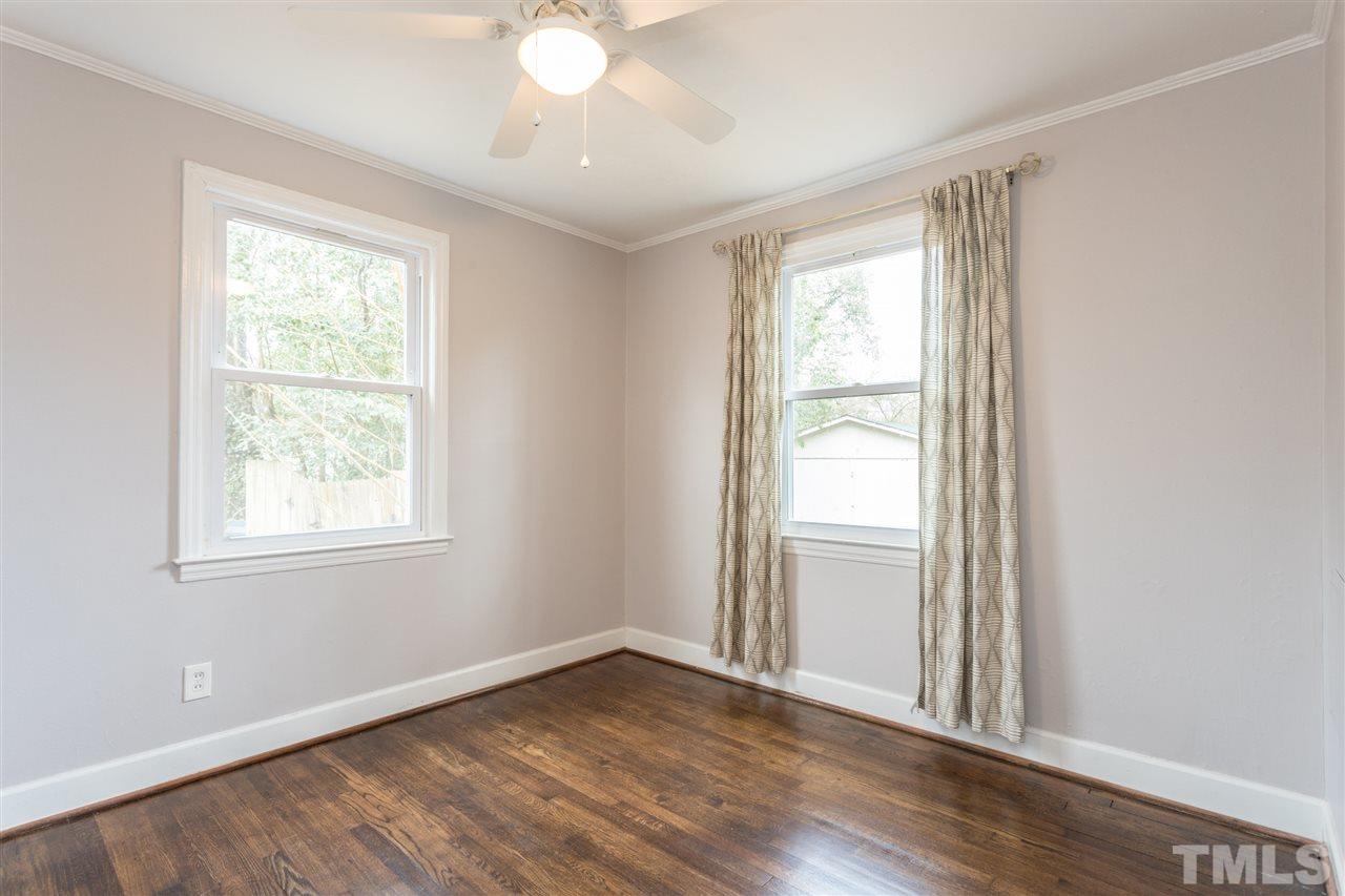 631 Brighton Road Raleigh, NC 27610 - Photo 14 of 25 a view of an empty room with wooden floor and a window