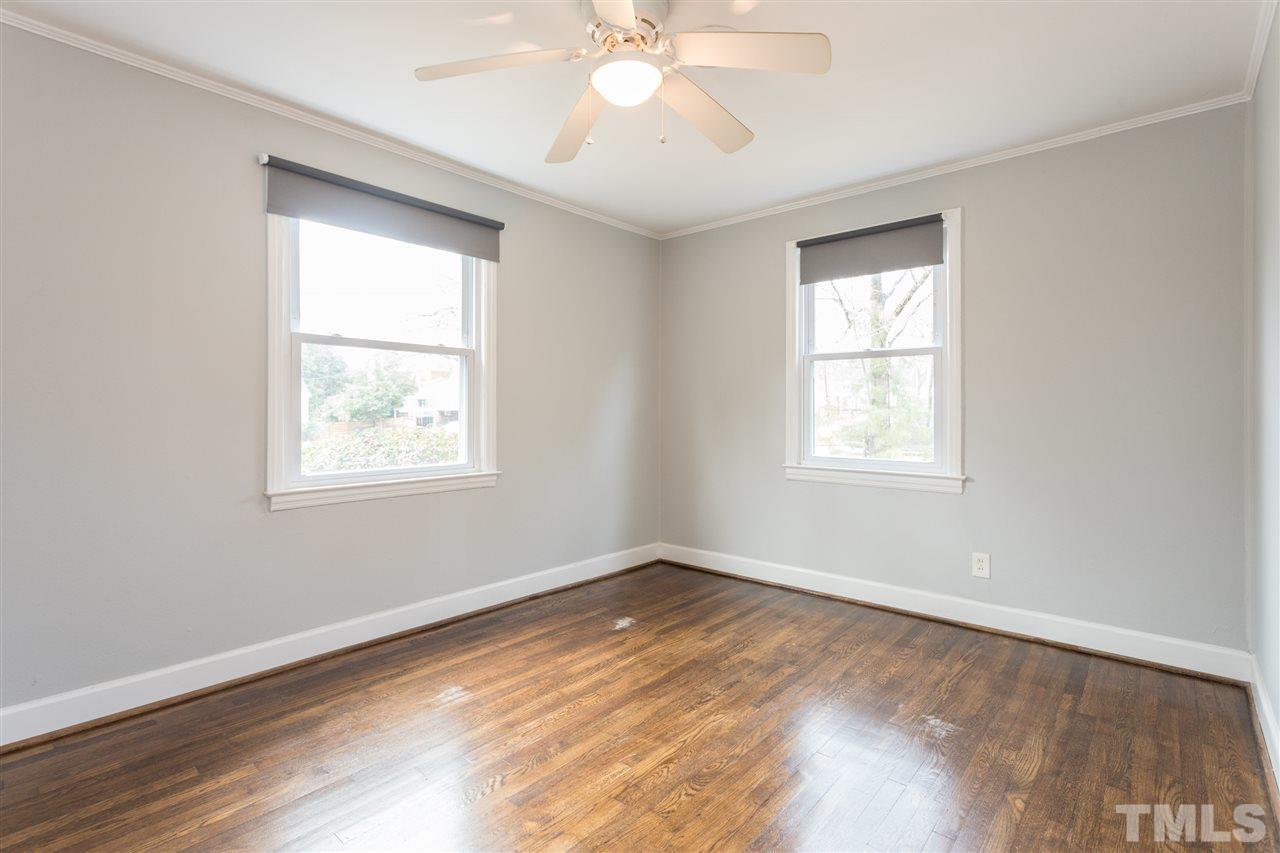 631 Brighton Road Raleigh, NC 27610 - Photo 16 of 25 a view of an empty room with wooden floor and a window