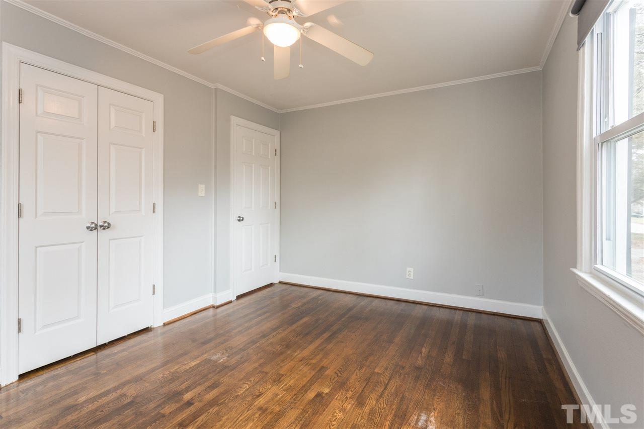 631 Brighton Road Raleigh, NC 27610 - Photo 17 of 25 an empty room with wooden floor and windows
