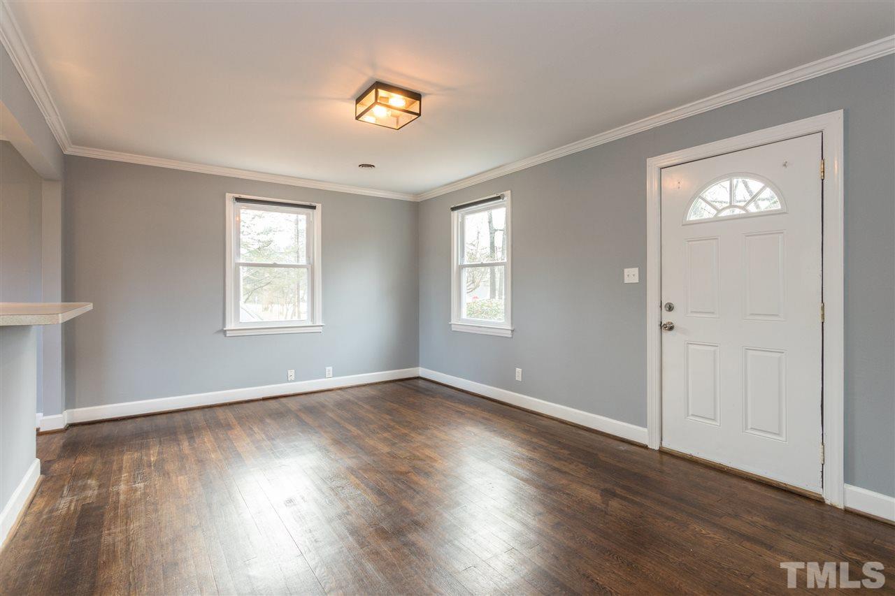 631 Brighton Road Raleigh, NC 27610 - Photo 3 of 25 a view of an empty room with window and wooden floor