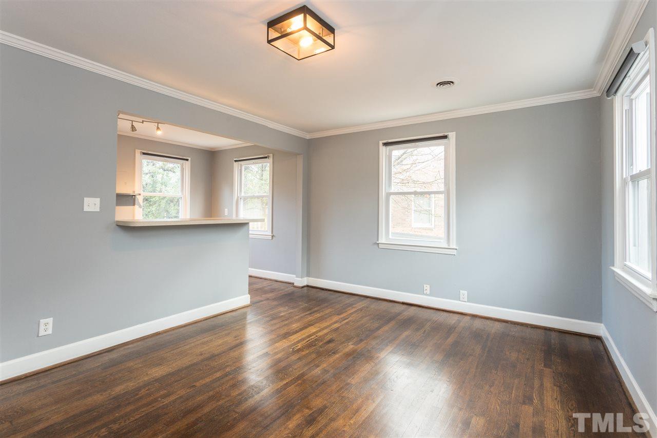 631 Brighton Road Raleigh, NC 27610 - Photo 5 of 25 an empty room with wooden floor and windows