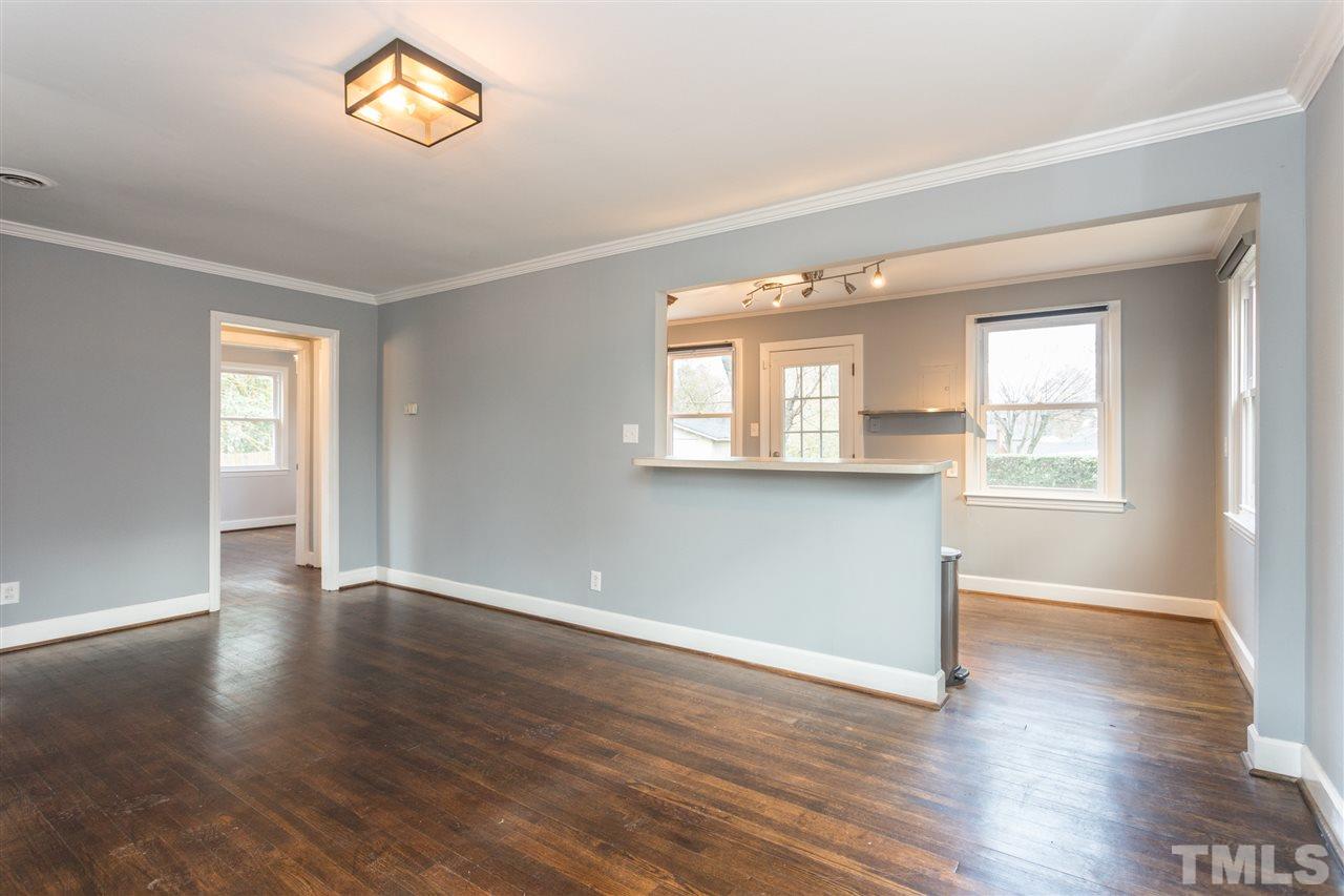 631 Brighton Road Raleigh, NC 27610 - Photo 6 of 25 an empty room with wooden floor and windows