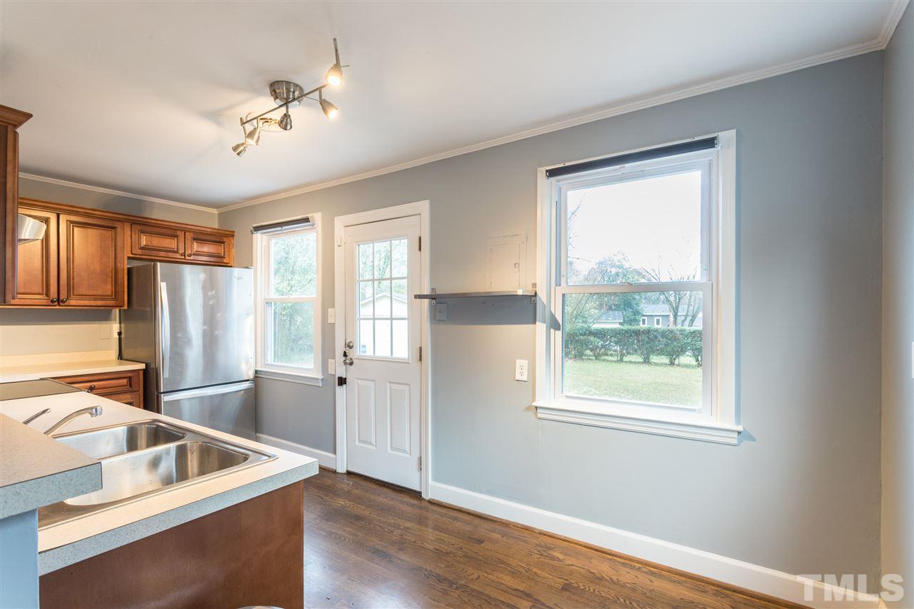631 Brighton Road Raleigh, NC 27610 - Photo 7 of 25 a view of a kitchen with a sink hardwood floor and a window