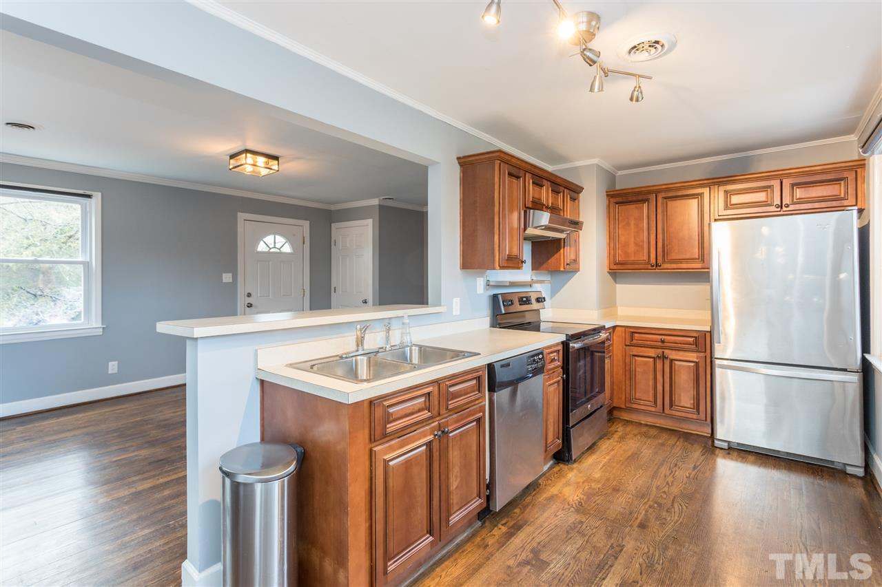 631 Brighton Road Raleigh, NC 27610 - Photo 8 of 25 a kitchen with a sink stove and refrigerator