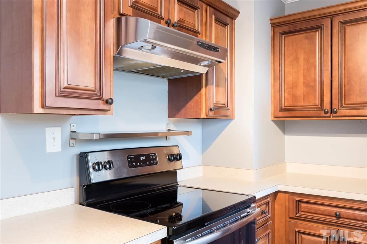 631 Brighton Road Raleigh, NC 27610 - Photo 10 of 25 a kitchen with stainless steel appliances granite countertop a stove and a microwave