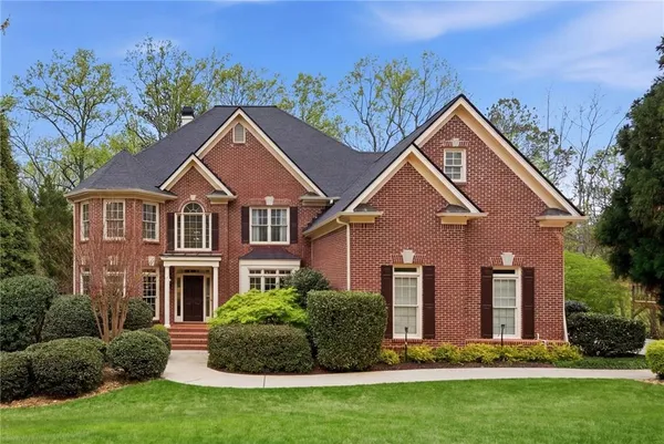 a front view of a house with a yard