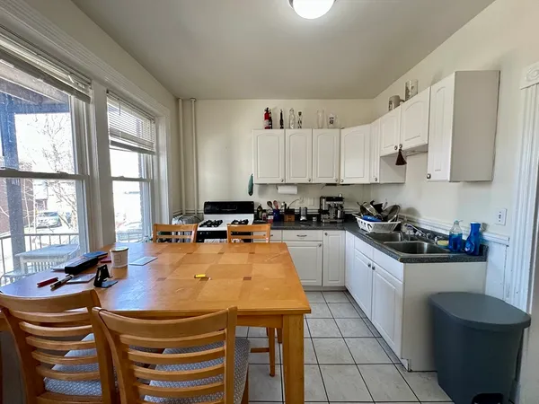 a kitchen with a sink a stove and cabinets