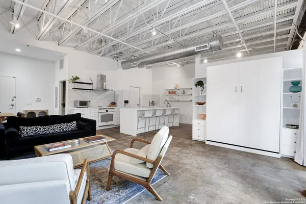 a kitchen with stainless steel appliances kitchen island granite countertop a refrigerator and a stove