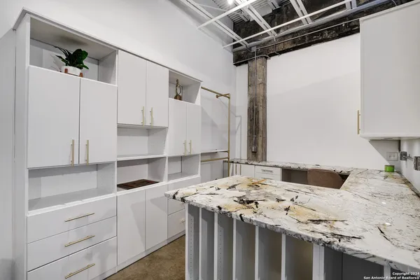 a kitchen with a sink appliances and cabinets