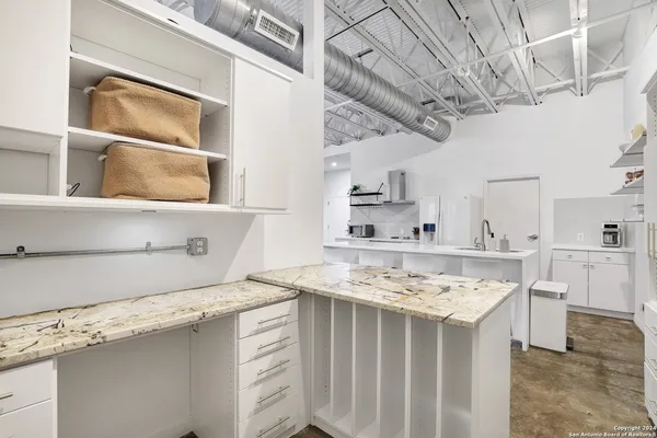 a view of kitchen with sink stove and refrigerator