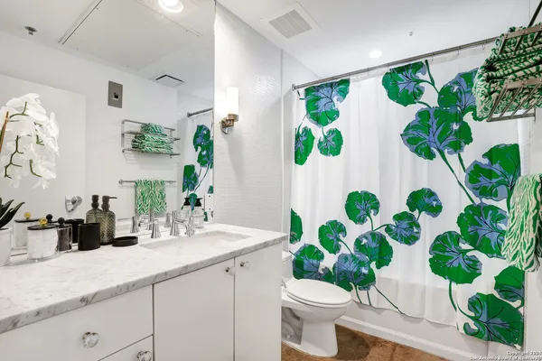 a bathroom with a sink a mirror a and a toilet