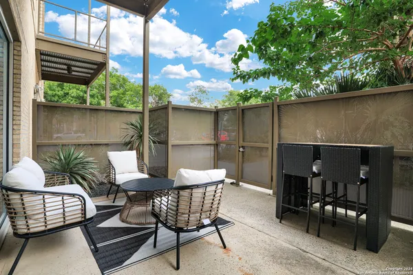 a outdoor space with a couch and chairs