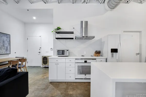 a kitchen with a stove and white cabinets