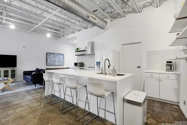 a kitchen with a sink stainless steel appliances and cabinets