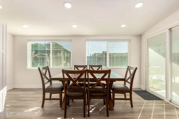a view of a dining room with furniture and wooden floor