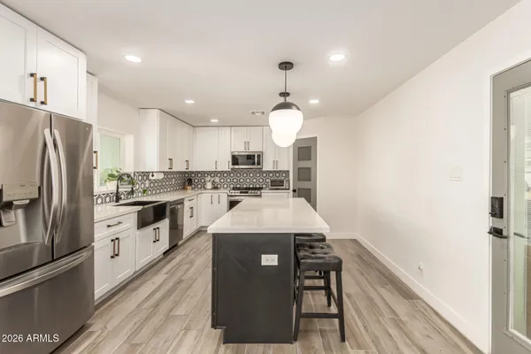 a kitchen with a white stove cabinets and wooden floor