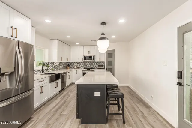 a kitchen with a white stove cabinets and wooden floor