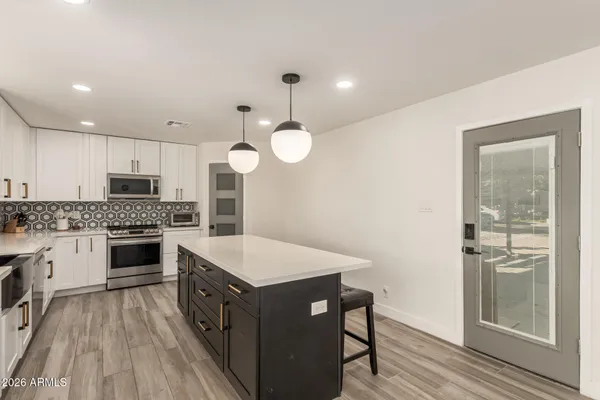a kitchen with a sink stove top oven and refrigerator