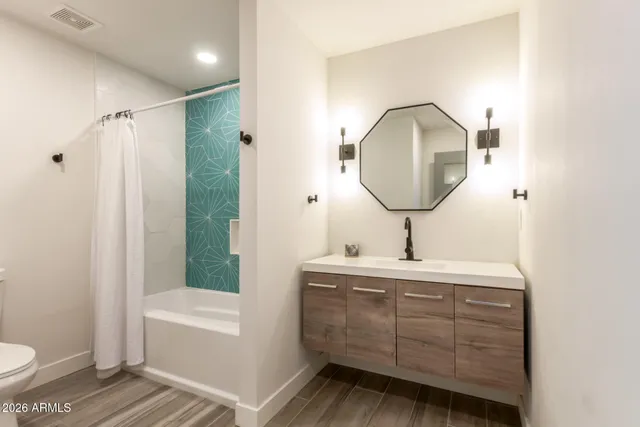 a bedroom with a bed and wooden floors