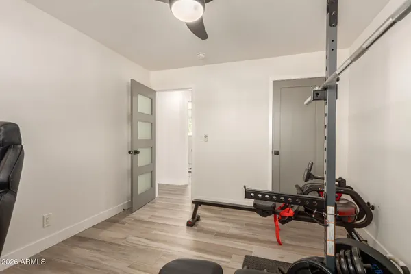 a bathroom with a sink a mirror and wooden floor