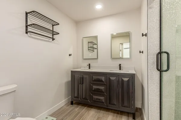 a bathroom with a granite countertop shower sink and vanity