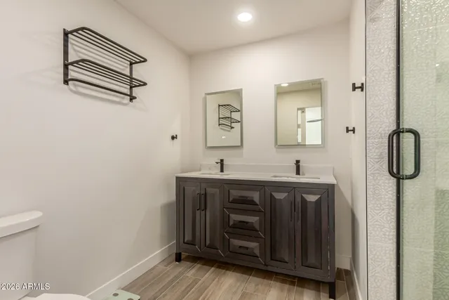 a bathroom with a granite countertop shower sink and vanity