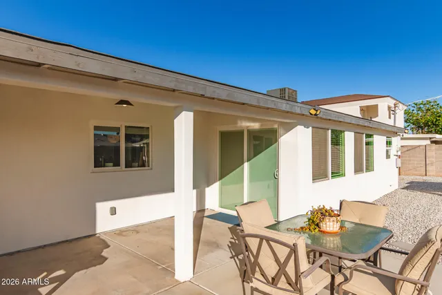 a view of a house with wooden fence