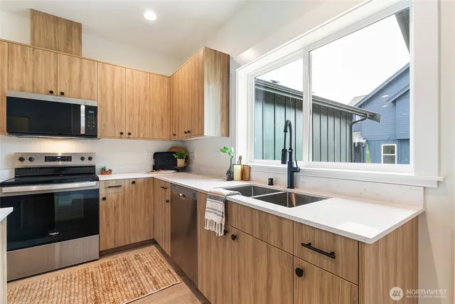 a kitchen with a sink stove and microwave