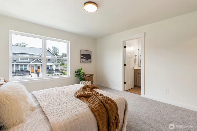a bedroom with a large bed and a large window